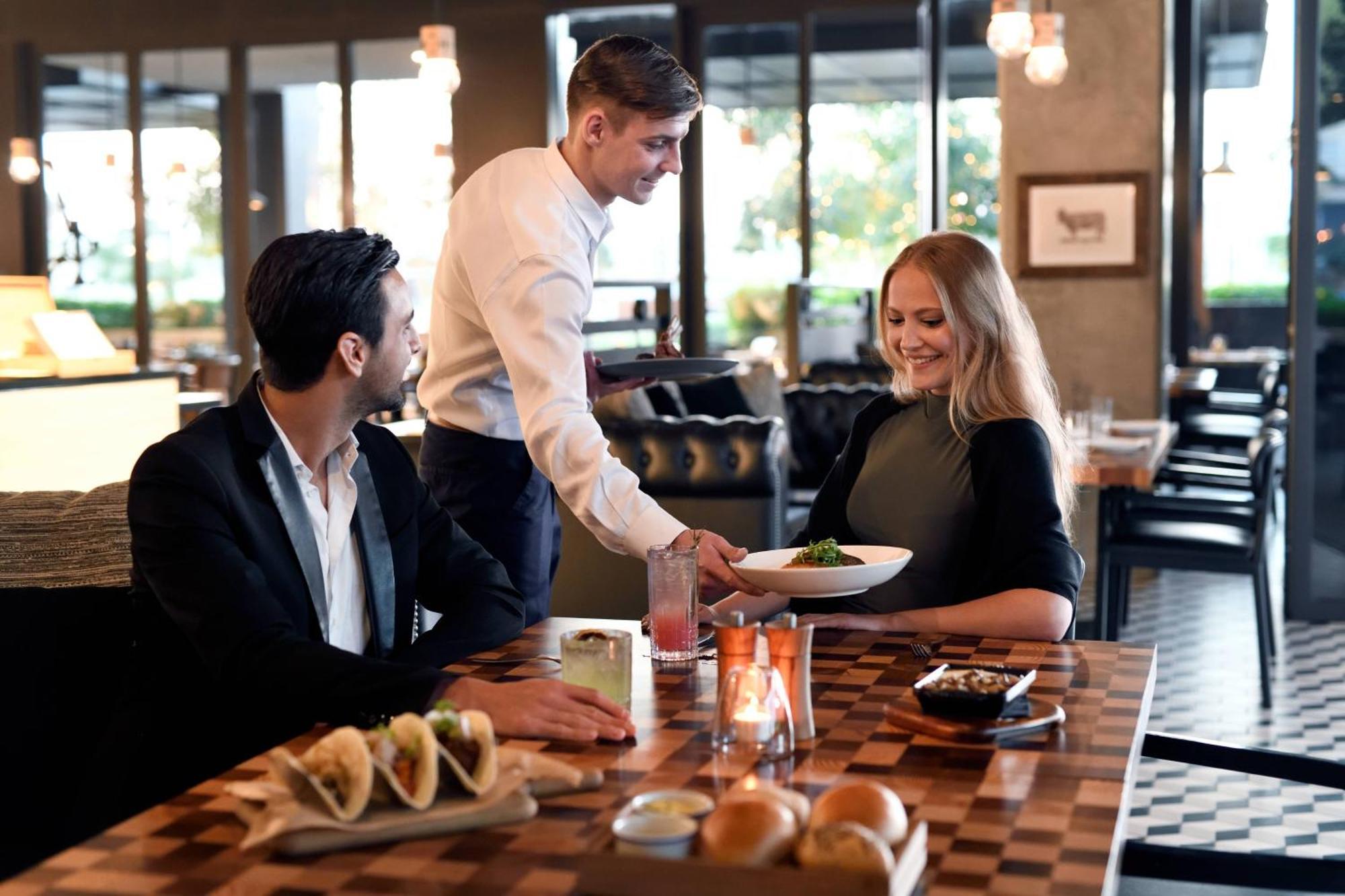 La Ville Hotel & Suites City Walk Dubai, Autograph Collection Экстерьер фото A waiter serving a couple